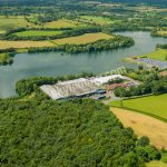 Treves factory from afar showing entire lake, drone aerial photograph